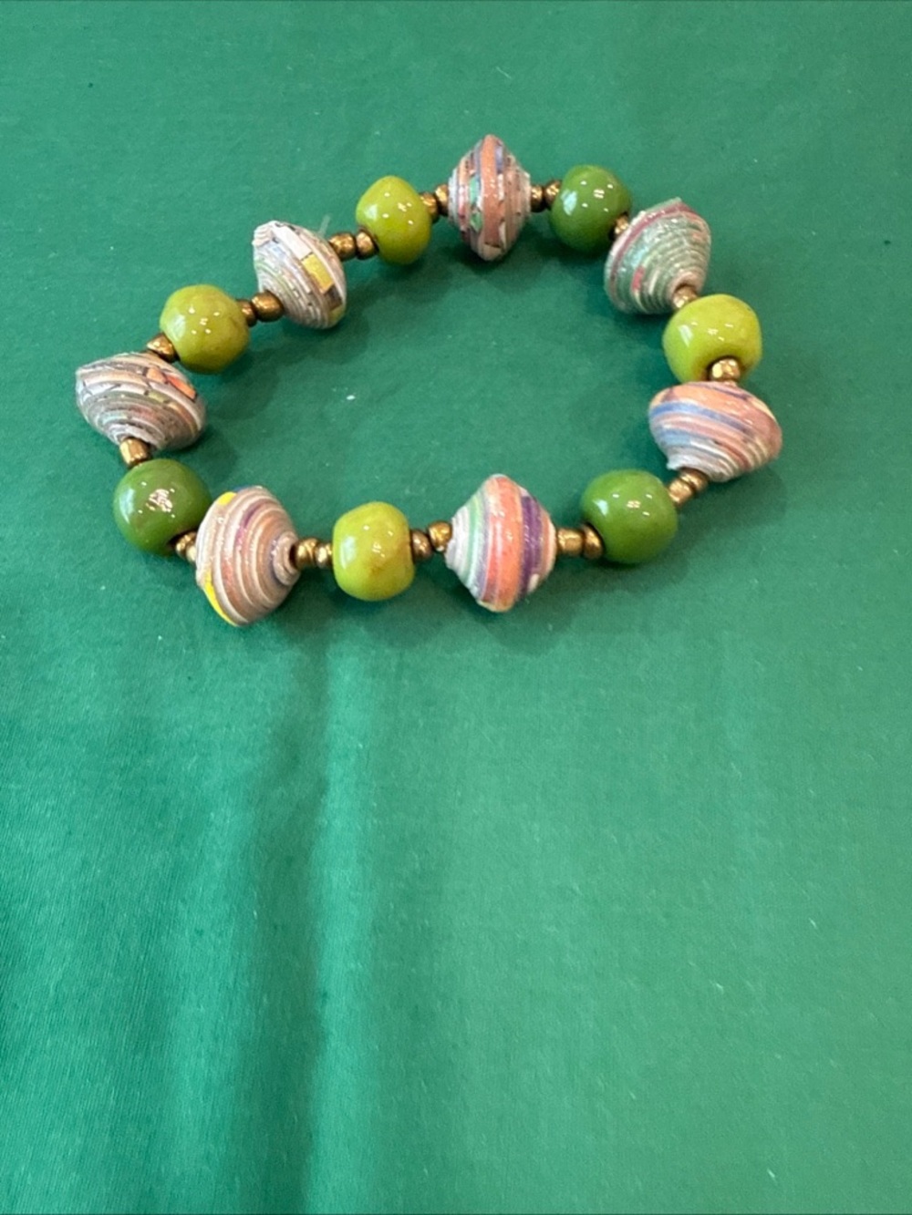 Stretchy beaded bracelet made with folded paper, with gold-tone bead separators
